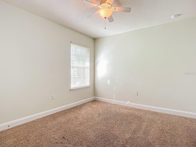 unfurnished room with ceiling fan, carpet floors, and a textured ceiling