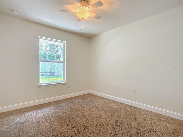 carpeted empty room with a textured ceiling and ceiling fan