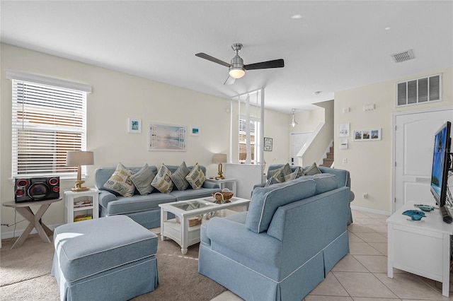 living room with ceiling fan and light tile patterned flooring