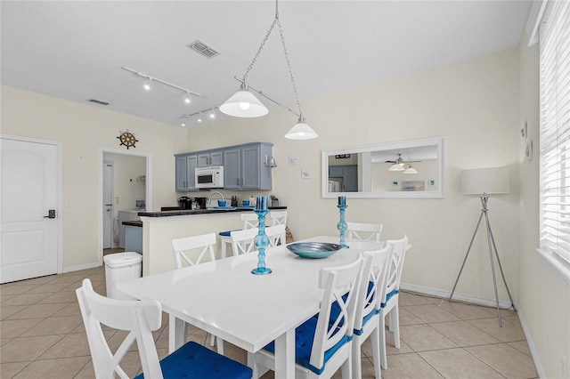 tiled dining room with ceiling fan