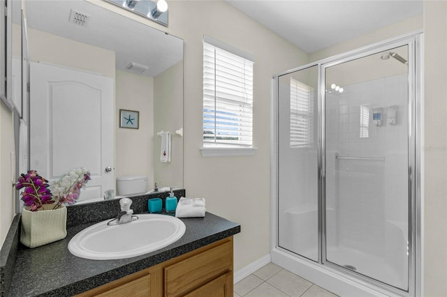 bathroom featuring walk in shower, tile patterned flooring, vanity, and toilet