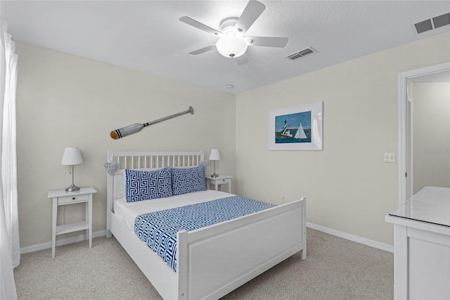 bedroom with ceiling fan and light carpet