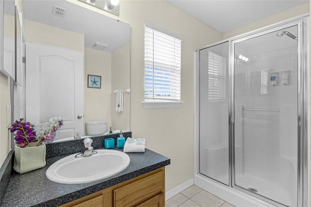 bathroom with walk in shower, tile patterned floors, vanity, and toilet