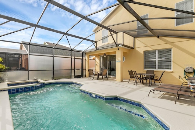 view of swimming pool with ceiling fan, a lanai, and a patio