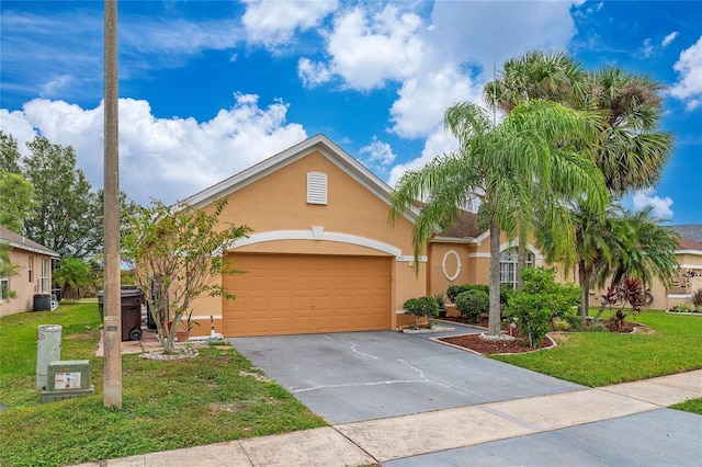 view of front of home featuring a front yard, central AC unit, and a garage