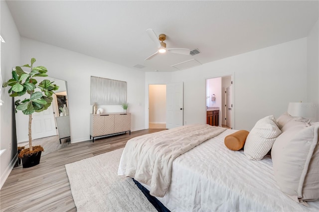 bedroom with ceiling fan, light hardwood / wood-style floors, and ensuite bath