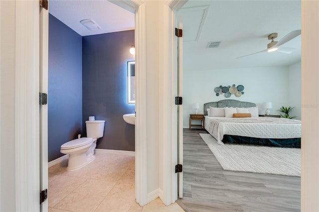 bathroom featuring hardwood / wood-style flooring, toilet, and ceiling fan