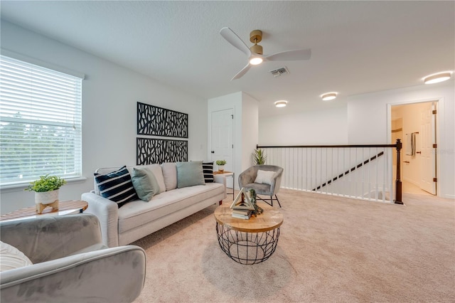 living room featuring carpet and ceiling fan