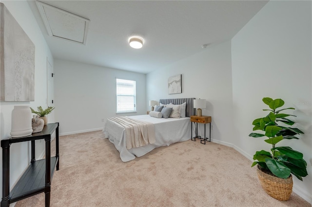carpeted bedroom featuring baseboards and attic access
