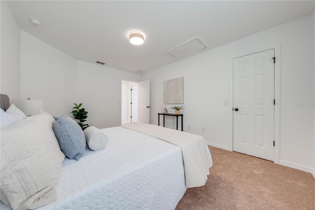 bedroom with baseboards, visible vents, and light colored carpet