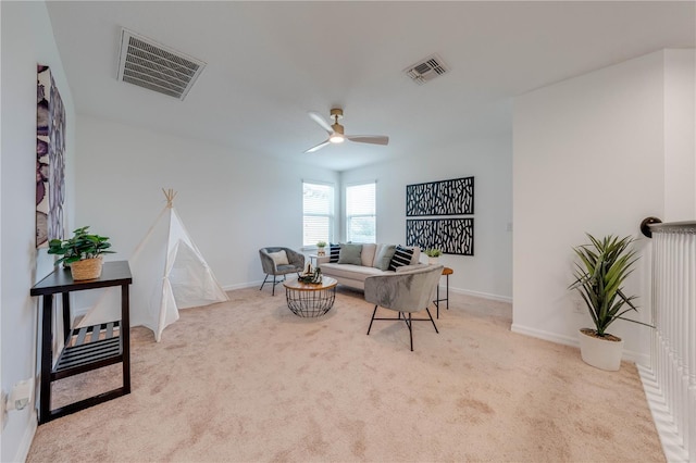 carpeted living room featuring ceiling fan