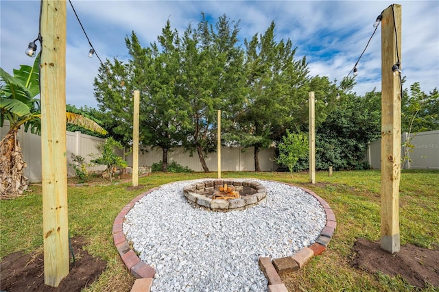 view of yard featuring an outdoor fire pit