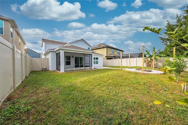 rear view of property with a yard and a patio