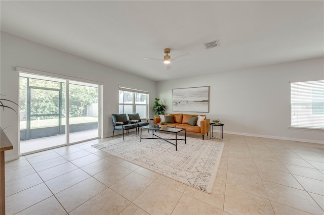 tiled living room featuring ceiling fan