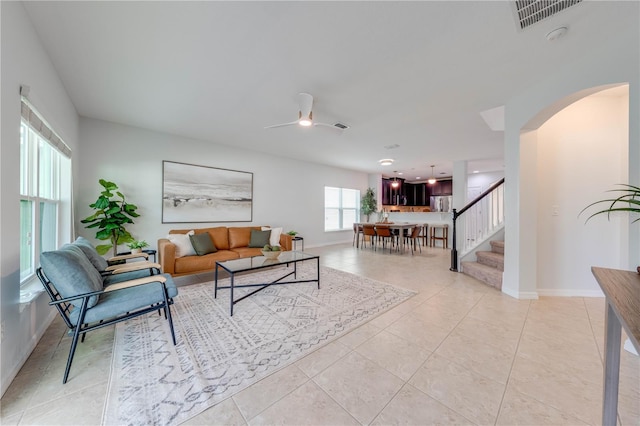 tiled living room with ceiling fan