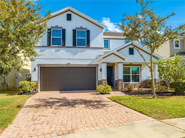 view of front of property with a front yard and a garage