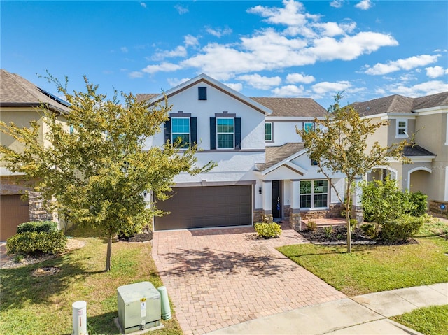 view of front of home with a garage and a front lawn