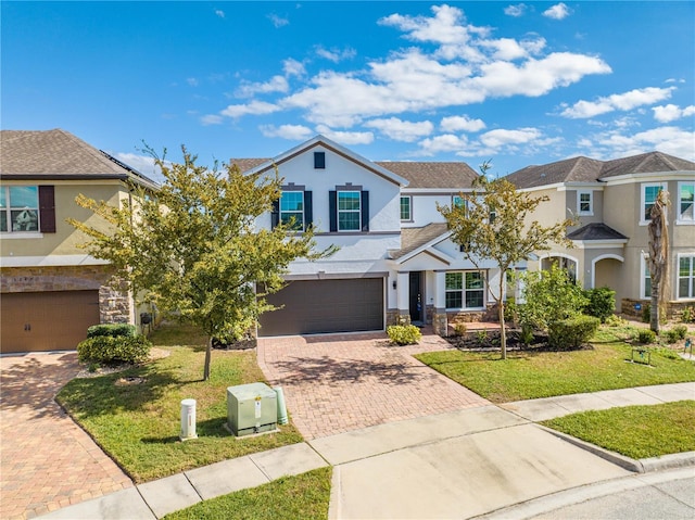 view of front of property featuring a garage and a front yard