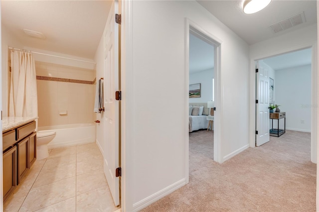 hallway featuring visible vents and baseboards