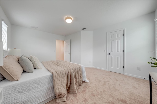 carpeted bedroom with visible vents and baseboards