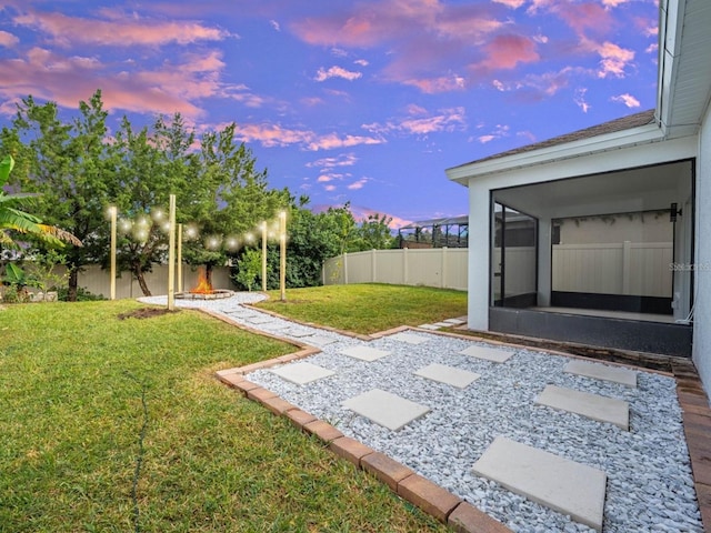view of yard with a sunroom and a fenced backyard