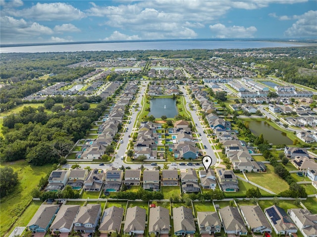 drone / aerial view featuring a residential view and a water view