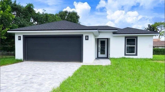 view of front facade with a garage and a front lawn