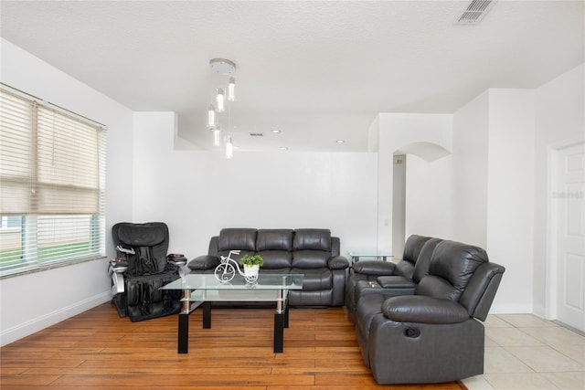 living room featuring a textured ceiling and light hardwood / wood-style flooring