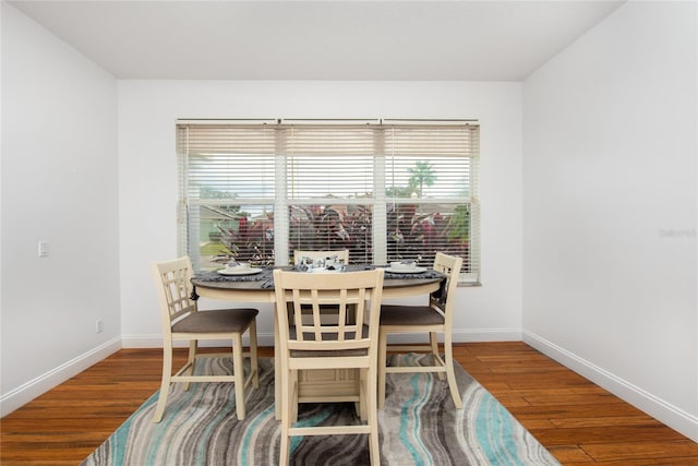 dining space with hardwood / wood-style flooring