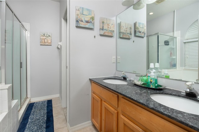 bathroom featuring vanity, an enclosed shower, and tile patterned floors