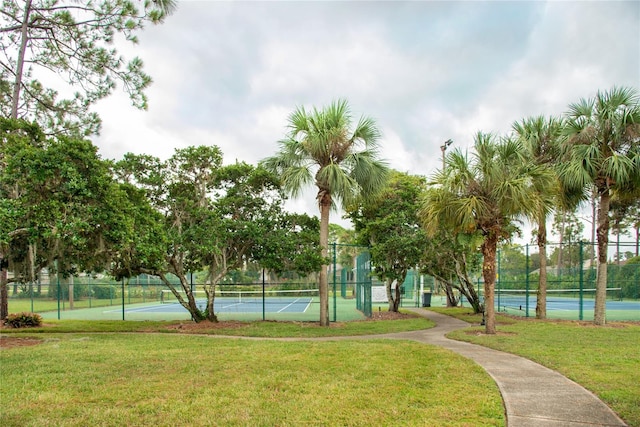 view of tennis court with a lawn