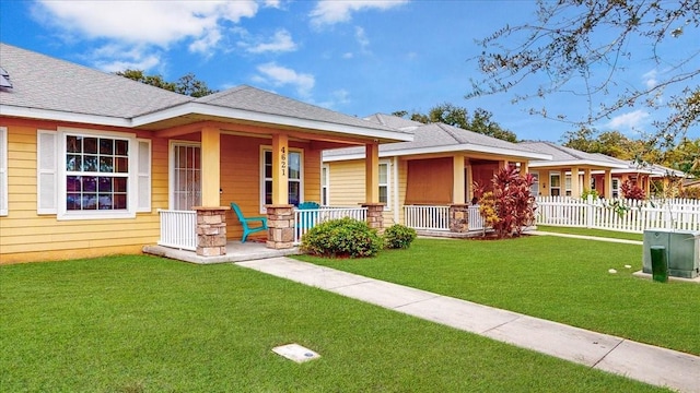 view of front of home featuring covered porch and a front yard