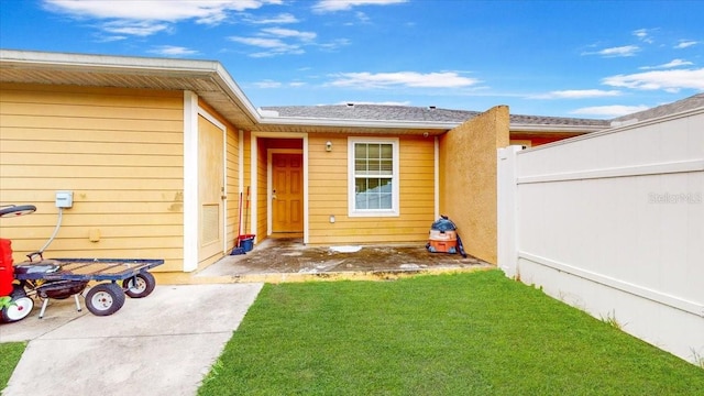 property entrance with a yard