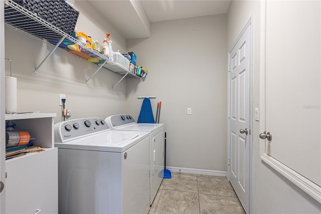 laundry room featuring light tile patterned flooring and washer and dryer