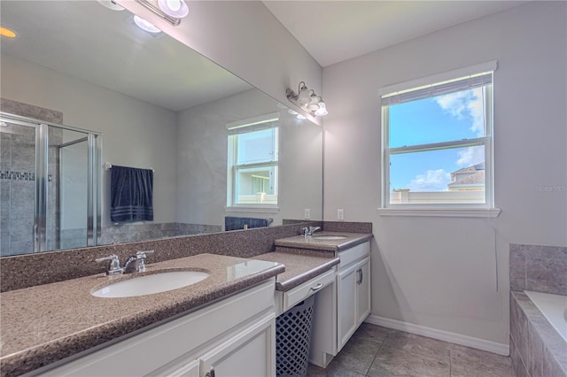 bathroom with tile patterned flooring, shower with separate bathtub, and vanity