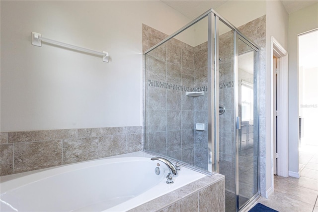 bathroom featuring tile patterned flooring and separate shower and tub