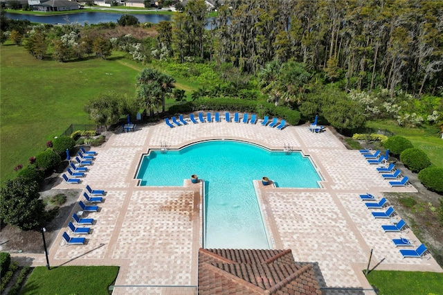 view of swimming pool with a water view and a patio