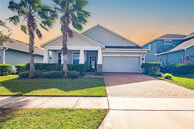 view of front of property featuring a garage and a yard