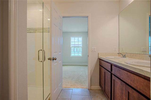 bathroom with tile patterned flooring, vanity, and a shower with door