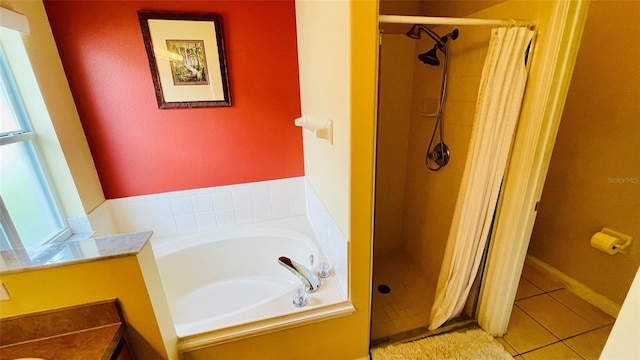 bathroom featuring a wealth of natural light, plus walk in shower, and tile patterned floors