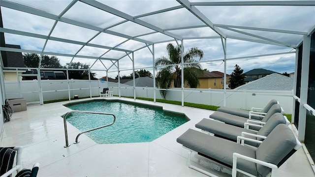 view of pool with a patio and glass enclosure