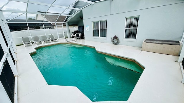 view of swimming pool with a patio and glass enclosure