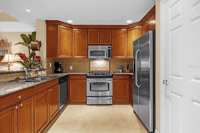 kitchen with sink, appliances with stainless steel finishes, ornamental molding, light stone countertops, and backsplash