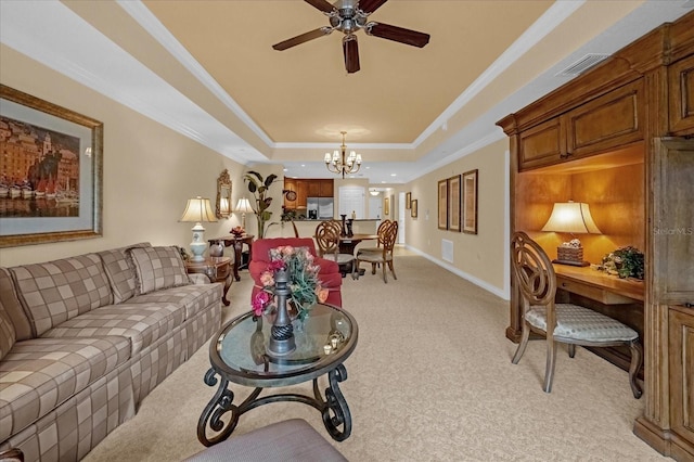 carpeted living room with crown molding, ceiling fan with notable chandelier, and a raised ceiling