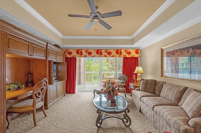 carpeted living room featuring ceiling fan, ornamental molding, and a raised ceiling