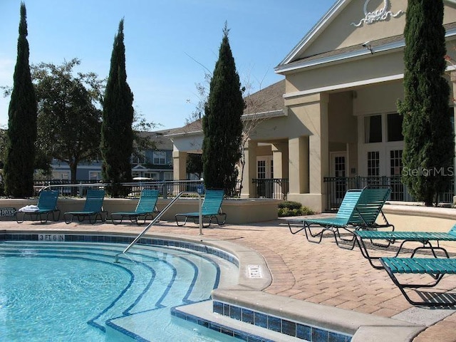 view of swimming pool featuring a patio area