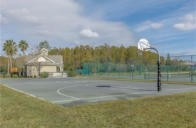 view of sport court featuring a yard