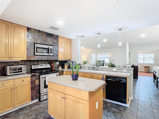 kitchen featuring tasteful backsplash, sink, a kitchen island, stainless steel appliances, and light brown cabinets