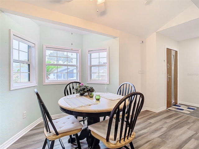 dining area featuring vaulted ceiling and hardwood / wood-style floors