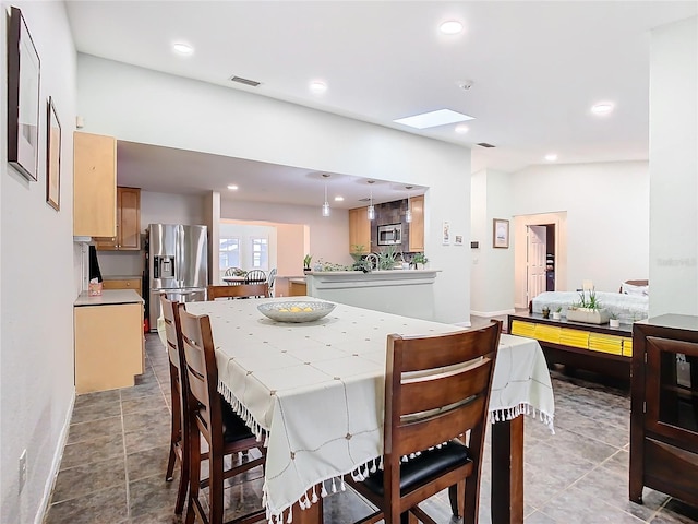 dining area featuring a skylight